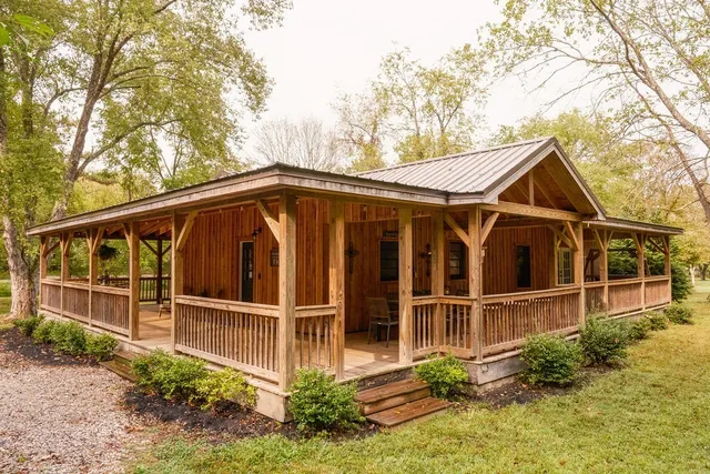 a view of a house with a yard and wooden fence