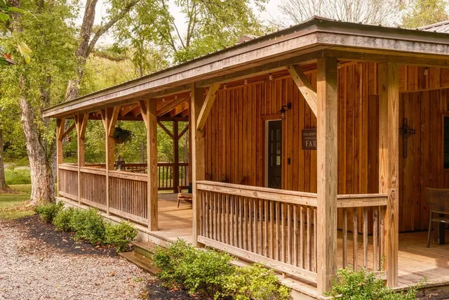 a view of a small house with wooden fence