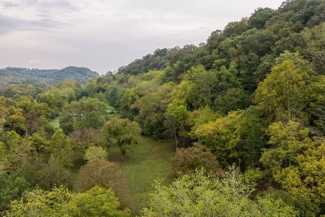a view of a balcony with wooden floor and fence