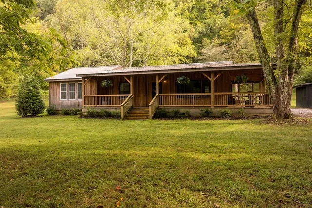 a view of yard with large trees