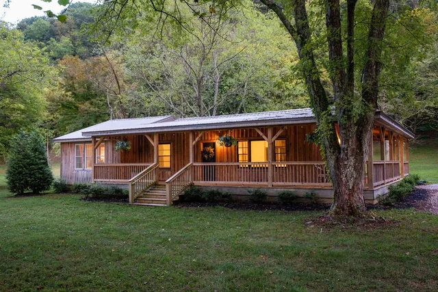 a view of a house with a backyard and a hammock