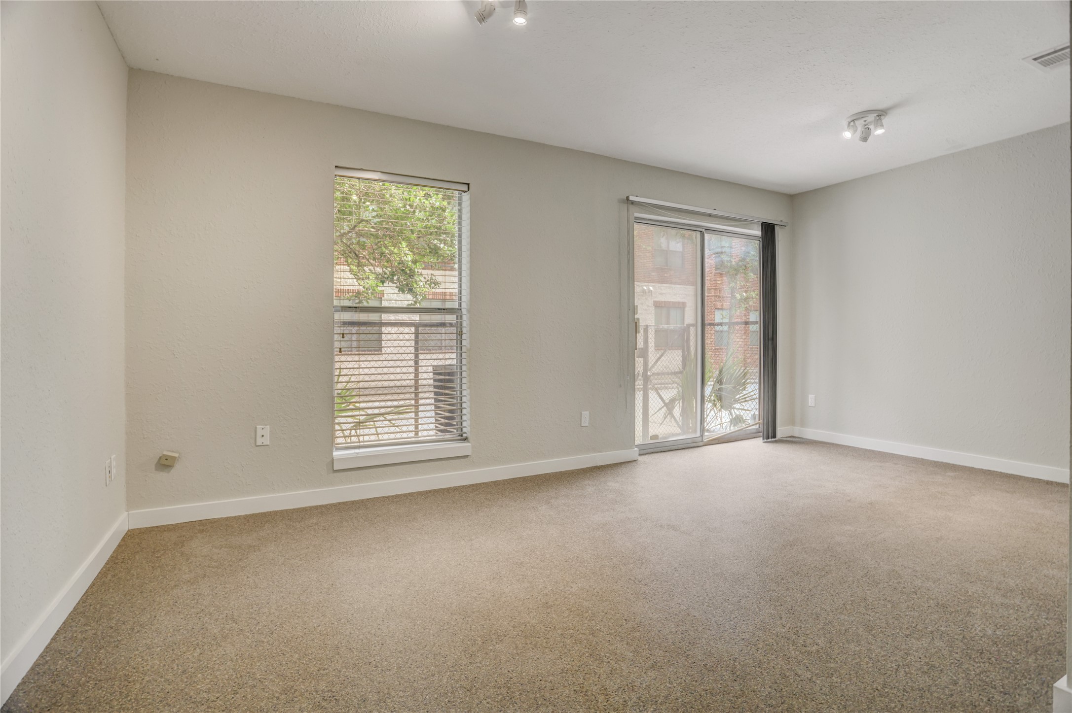 910 Ruthven Street Houston, TX 77019 - Photo 13 of 35 Was a bedroom and a study with the wall removed it’s over scaled and boasts, sliding patio door, & stained concrete floors,
