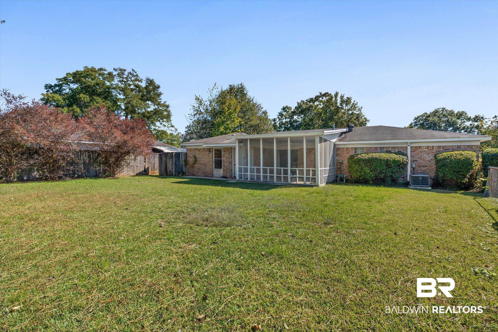 6300 Christopher Drive North Mobile, AL 36609 - Photo 18 of 22 Rear view of property with brick siding and a sunroom