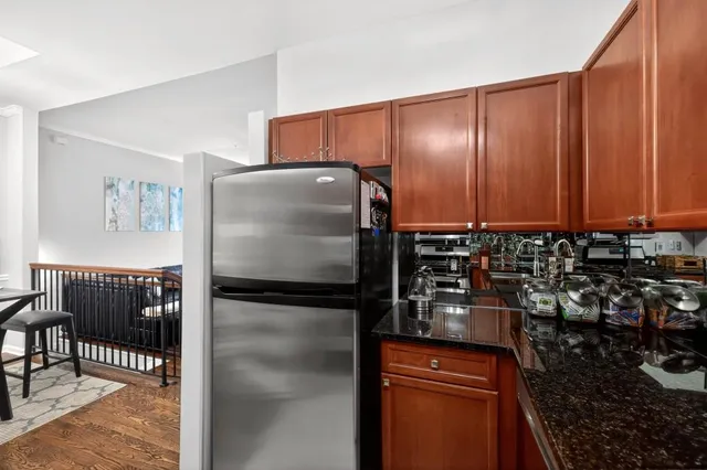 a kitchen with a refrigerator and a stove top oven