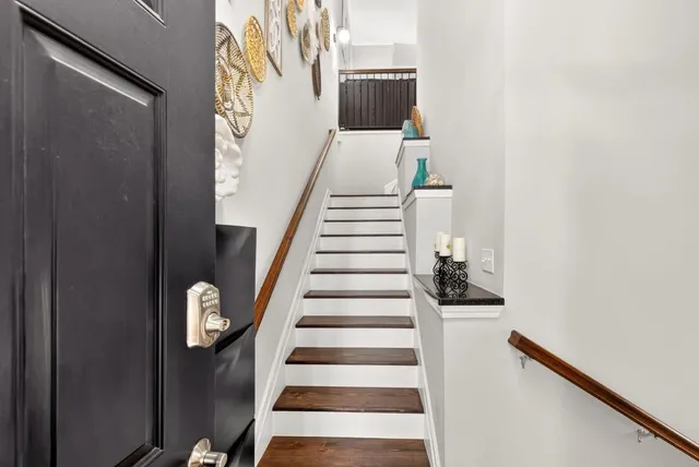 a view of entryway and hall with wooden floor