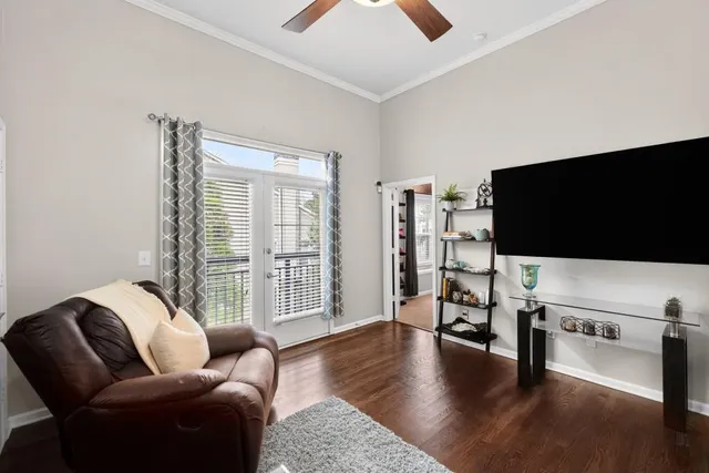 a living room with furniture and a flat screen tv
