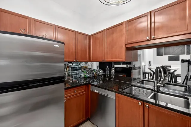 a kitchen with stainless steel appliances granite countertop a sink stove and cabinets
