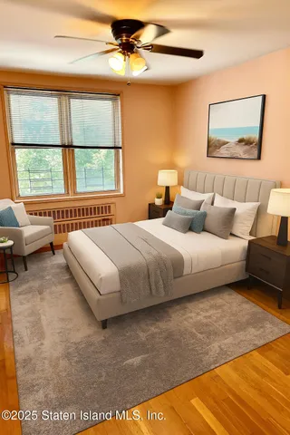 a bedroom with a bed a couch and a window