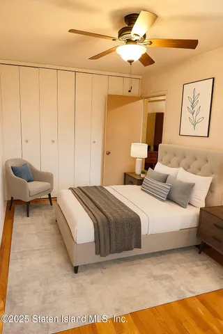 a spacious bedroom with a bed and a chandelier