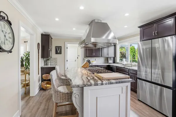 a kitchen that has a sink a stove and a refrigerator