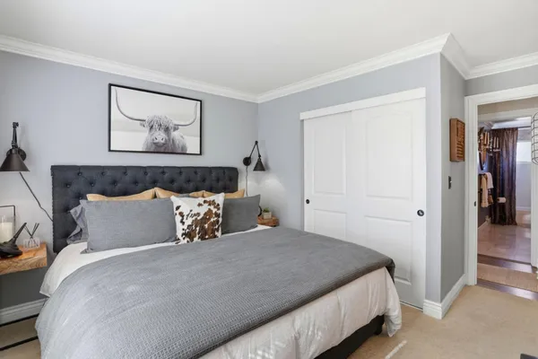 a bedroom with bed and wall painting