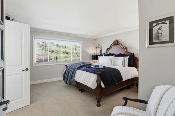 a bedroom with a bed and window