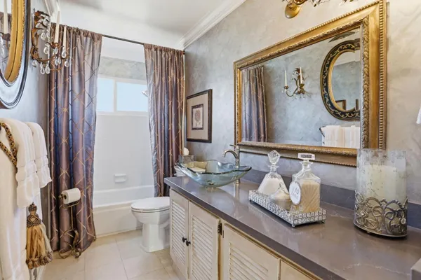 a bathroom with a granite countertop sink a toilet and a mirror
