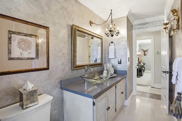 a bathroom with a granite countertop sink a toilet a mirror and shower