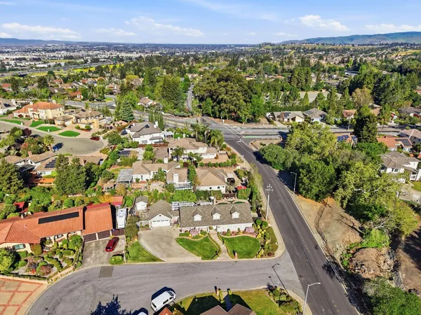 an aerial view of residential houses with outdoor space and river