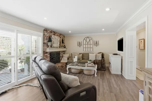 a living room with fireplace furniture and a large window