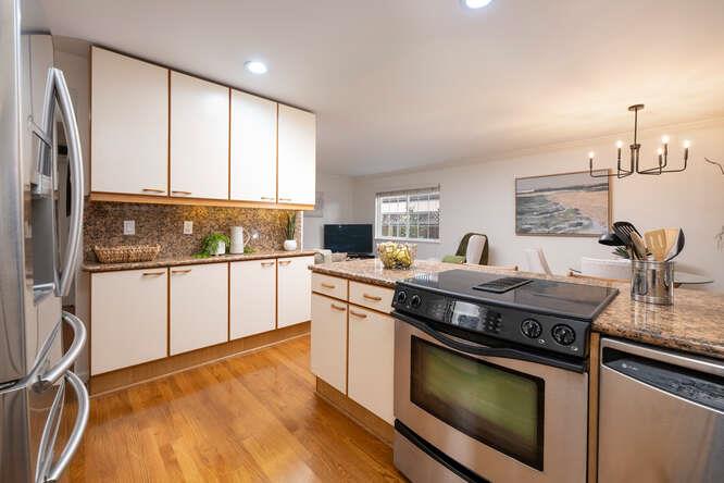 906 Bluebell Way Sunnyvale, CA 94086 - Photo 11 of 27 a kitchen with stainless steel appliances granite countertop a stove a sink and a refrigerator