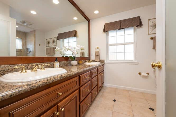 906 Bluebell Way Sunnyvale, CA 94086 - Photo 18 of 27 a bathroom with a granite countertop sink a mirror and a shower
