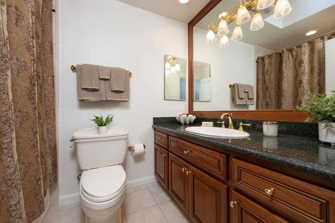 906 Bluebell Way Sunnyvale, CA 94086 - Photo 21 of 27 a bathroom with a granite countertop toilet sink and mirror