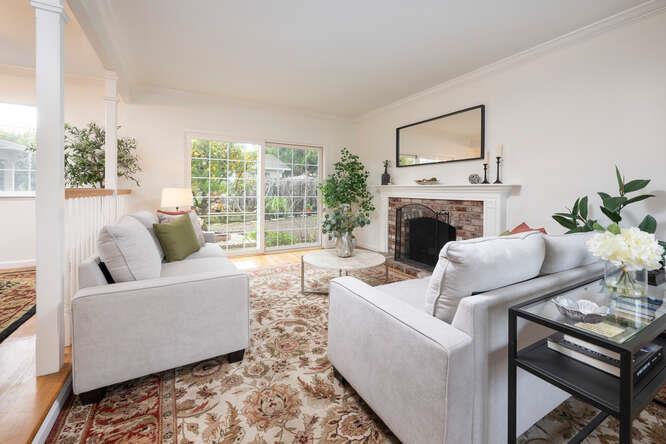 906 Bluebell Way Sunnyvale, CA 94086 - Photo 5 of 27 a living room with furniture a fireplace and a floor to ceiling window