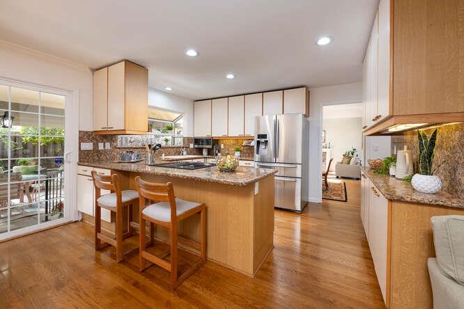 906 Bluebell Way Sunnyvale, CA 94086 - Photo 10 of 27 a kitchen with stainless steel appliances granite countertop a stove a sink a refrigerator and chairs