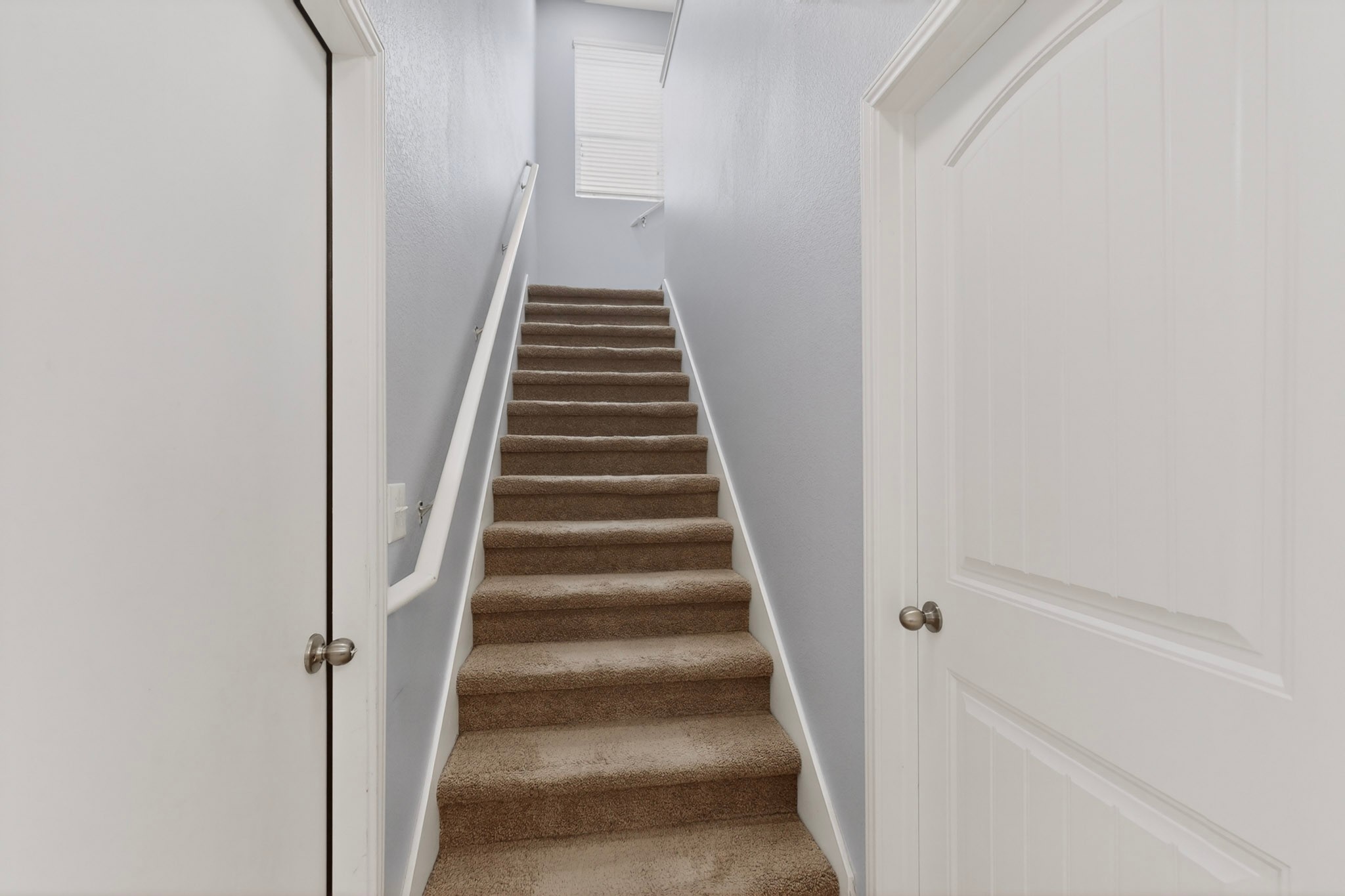 14513 Esker Road Manor, TX 78653 - Photo 7 of 38 A well-lit stairway offers comfortable carpeted steps leading to the upper level.