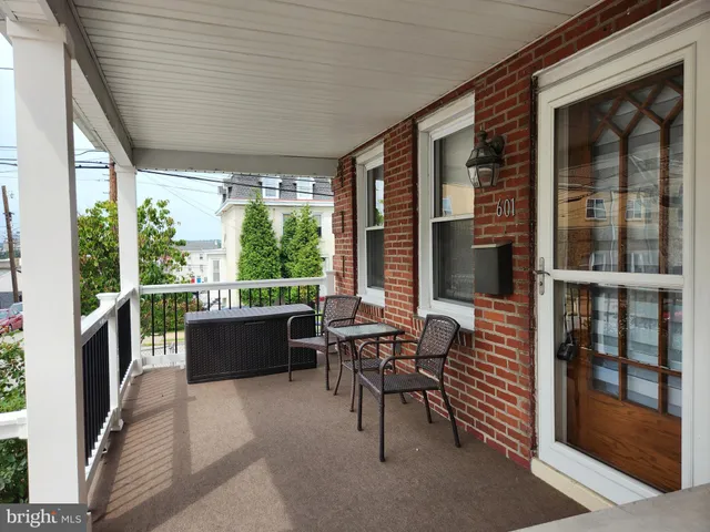 a kitchen with a refrigerator wooden floor a sink and a large window