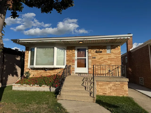 a view of a house with backyard porch and sitting area
