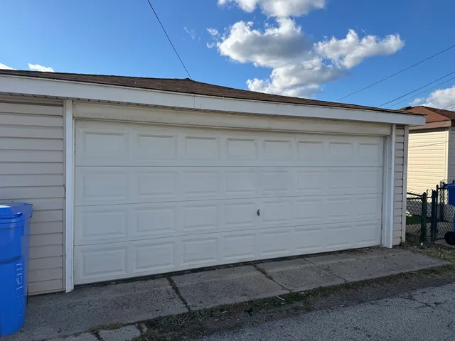 a view of a house with a white wall and roof