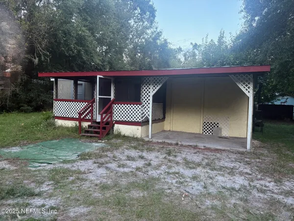 a view of a house with a yard and garage