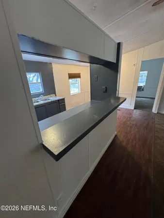 a view of a livingroom with a ceiling fan and window