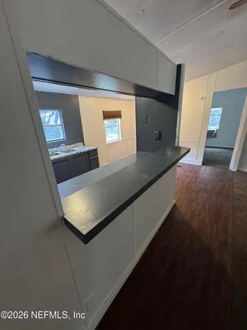 a view of a livingroom with a ceiling fan and window