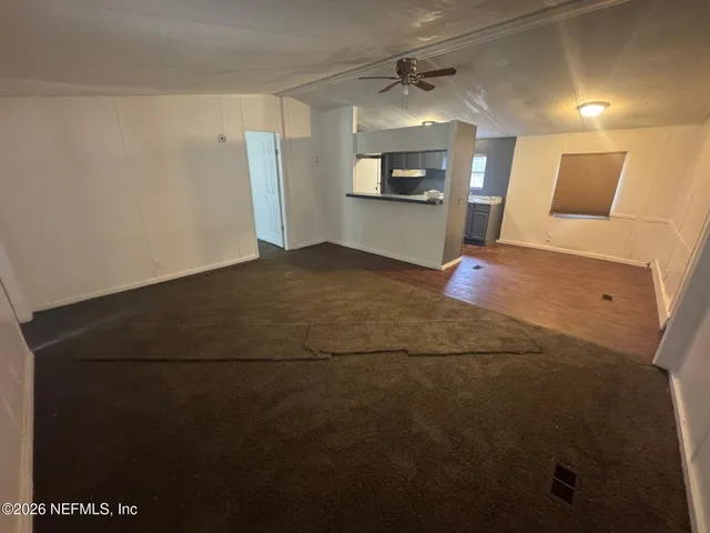 a large room with wooden floor and windows