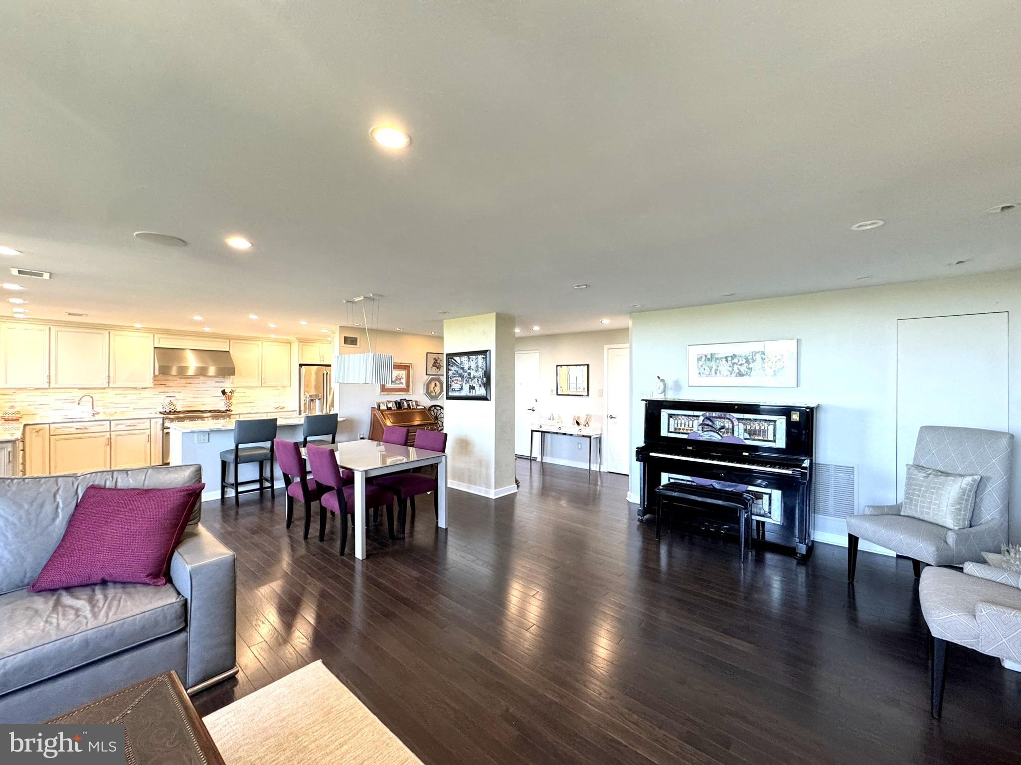 191 Presidential Boulevard, Unit R828 Bala Cynwyd, PA 19004 - Photo 20 of 50 a living room with furniture and a dining table with wooden floor