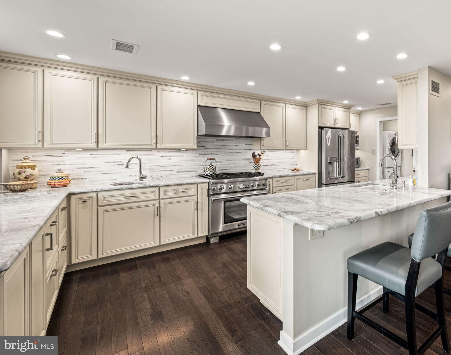 191 Presidential Boulevard, Unit R828 Bala Cynwyd, PA 19004 - Photo 22 of 50 a kitchen with a sink window and cabinets