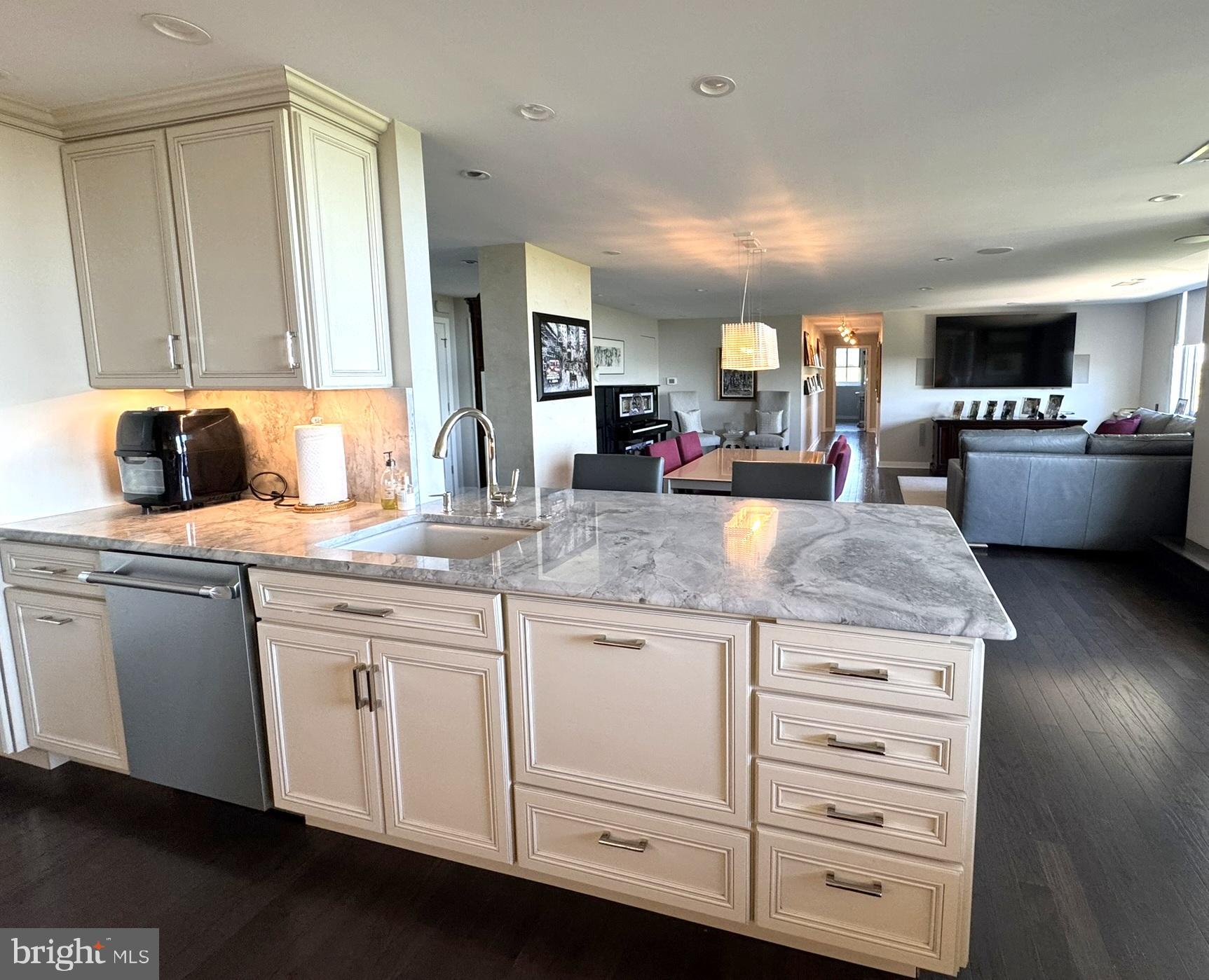 191 Presidential Boulevard, Unit R828 Bala Cynwyd, PA 19004 - Photo 23 of 50 a kitchen with granite countertop a sink dishwasher stove and cabinets