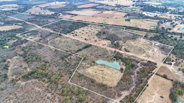 a view of a dry yard with trees