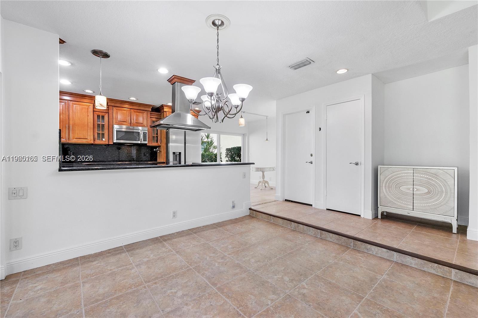 5667 North Cameo Drive Boca Raton, FL 33433 - Photo 18 of 32 a view of a kitchen with a sink and chandelier