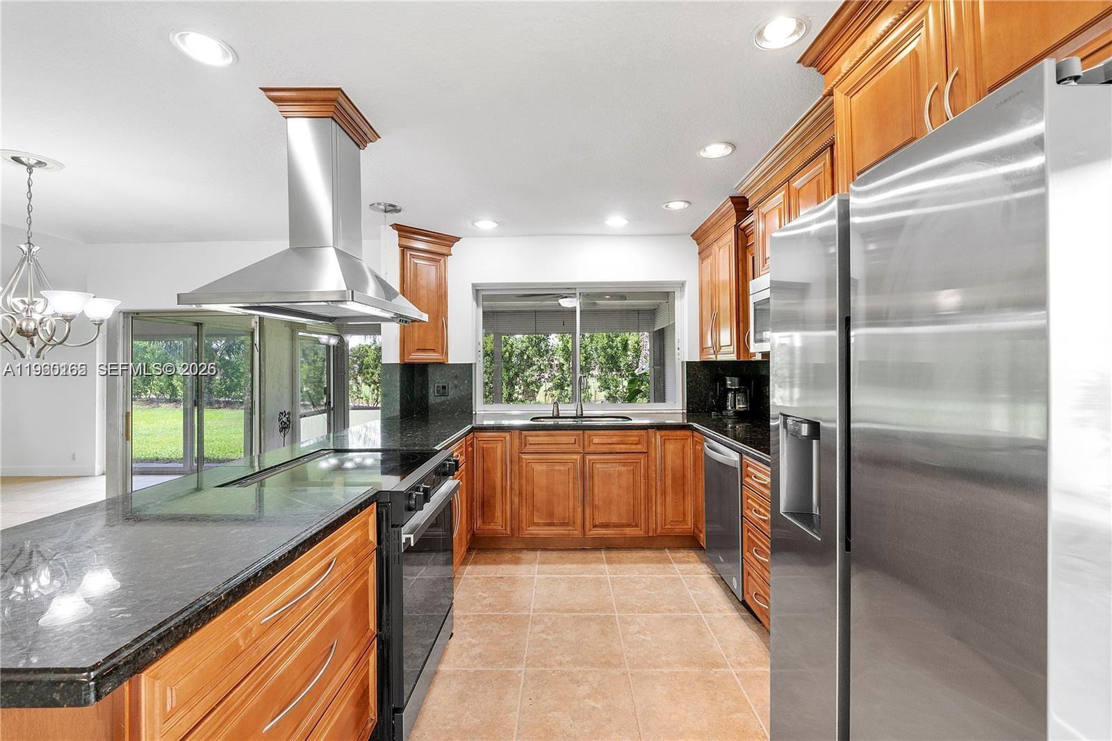 5667 North Cameo Drive Boca Raton, FL 33433 - Photo 21 of 32 a kitchen with stainless steel appliances granite countertop a refrigerator and a sink