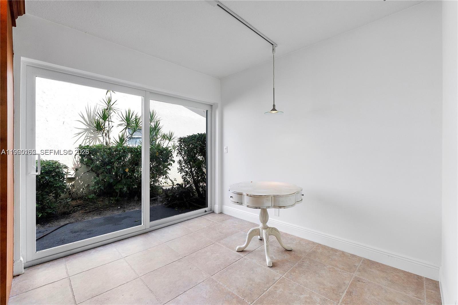 5667 North Cameo Drive Boca Raton, FL 33433 - Photo 23 of 32 a view of a room with a floor to ceiling window and an outdoor space