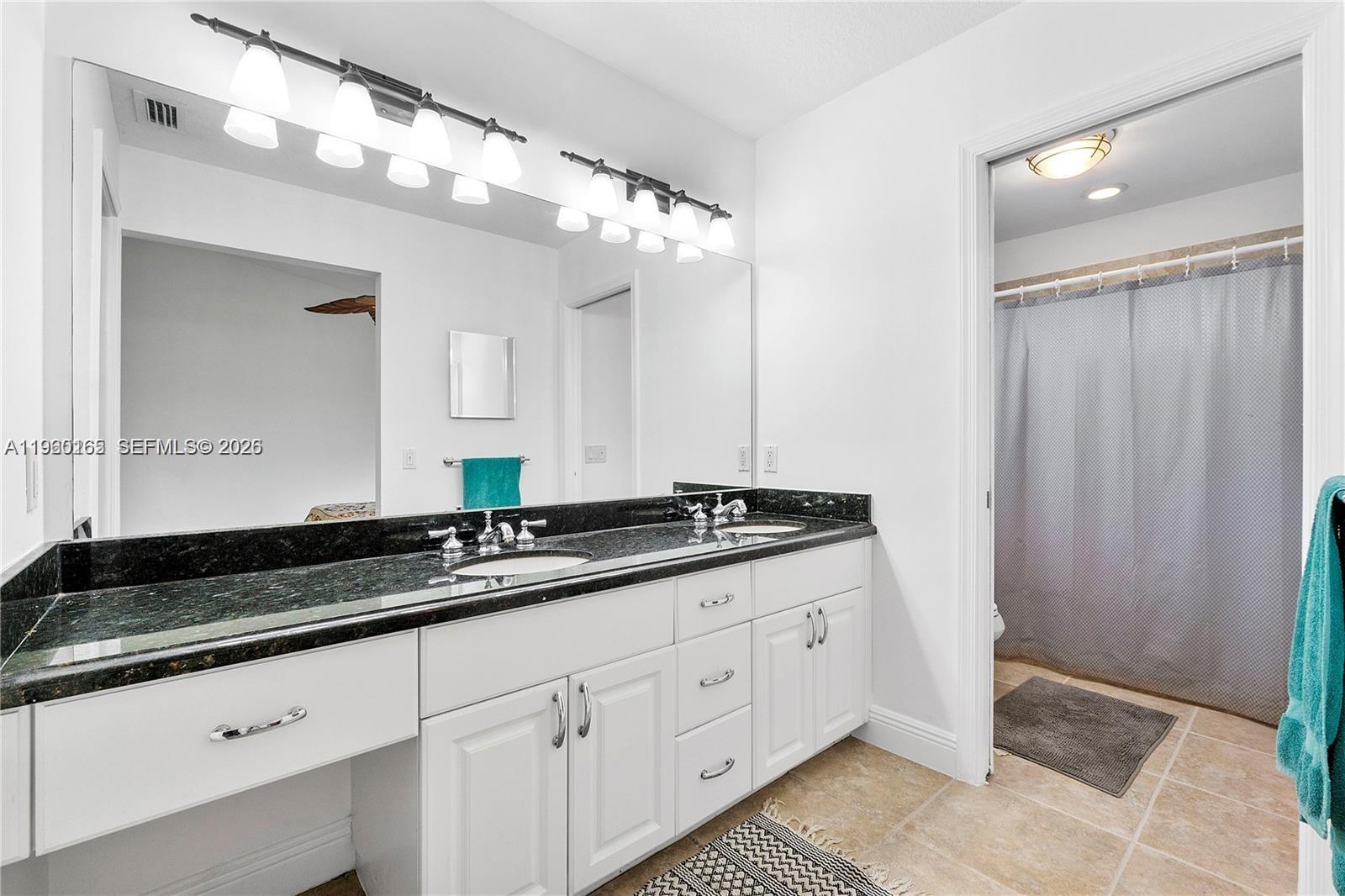 5667 North Cameo Drive Boca Raton, FL 33433 - Photo 27 of 32 a bathroom with a granite countertop sink and a mirror