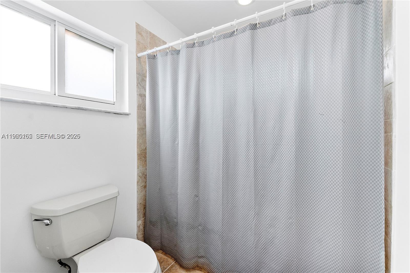 5667 North Cameo Drive Boca Raton, FL 33433 - Photo 28 of 32 a white toilet sitting next to a shower