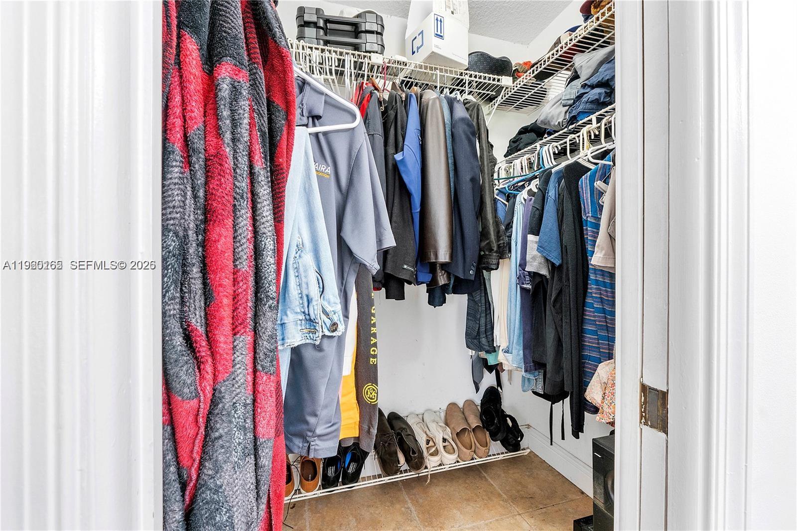 5667 North Cameo Drive Boca Raton, FL 33433 - Photo 29 of 32 a view of walk in closet with clothes