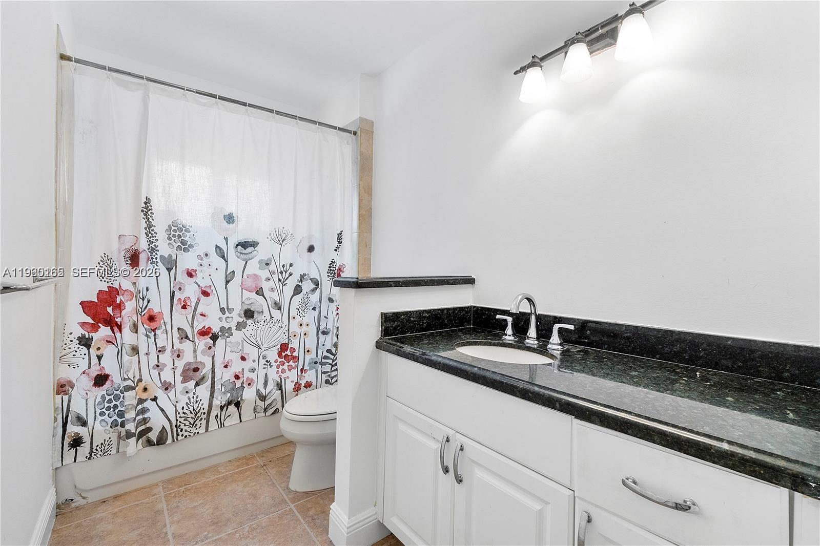 5667 North Cameo Drive Boca Raton, FL 33433 - Photo 30 of 32 a bathroom with a granite countertop sink and a mirror