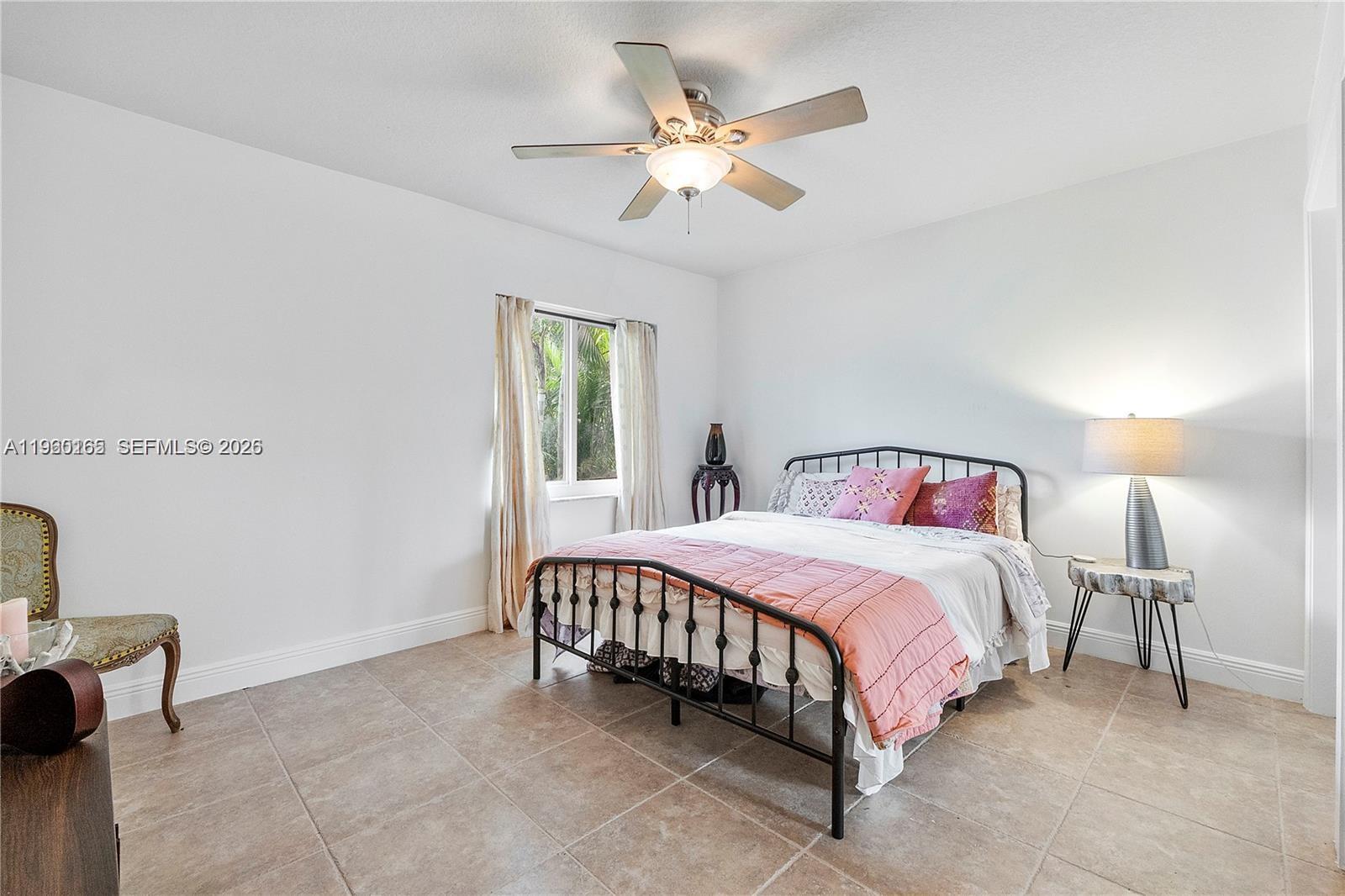 5667 North Cameo Drive Boca Raton, FL 33433 - Photo 31 of 32 a bedroom with a bed and a chandelier