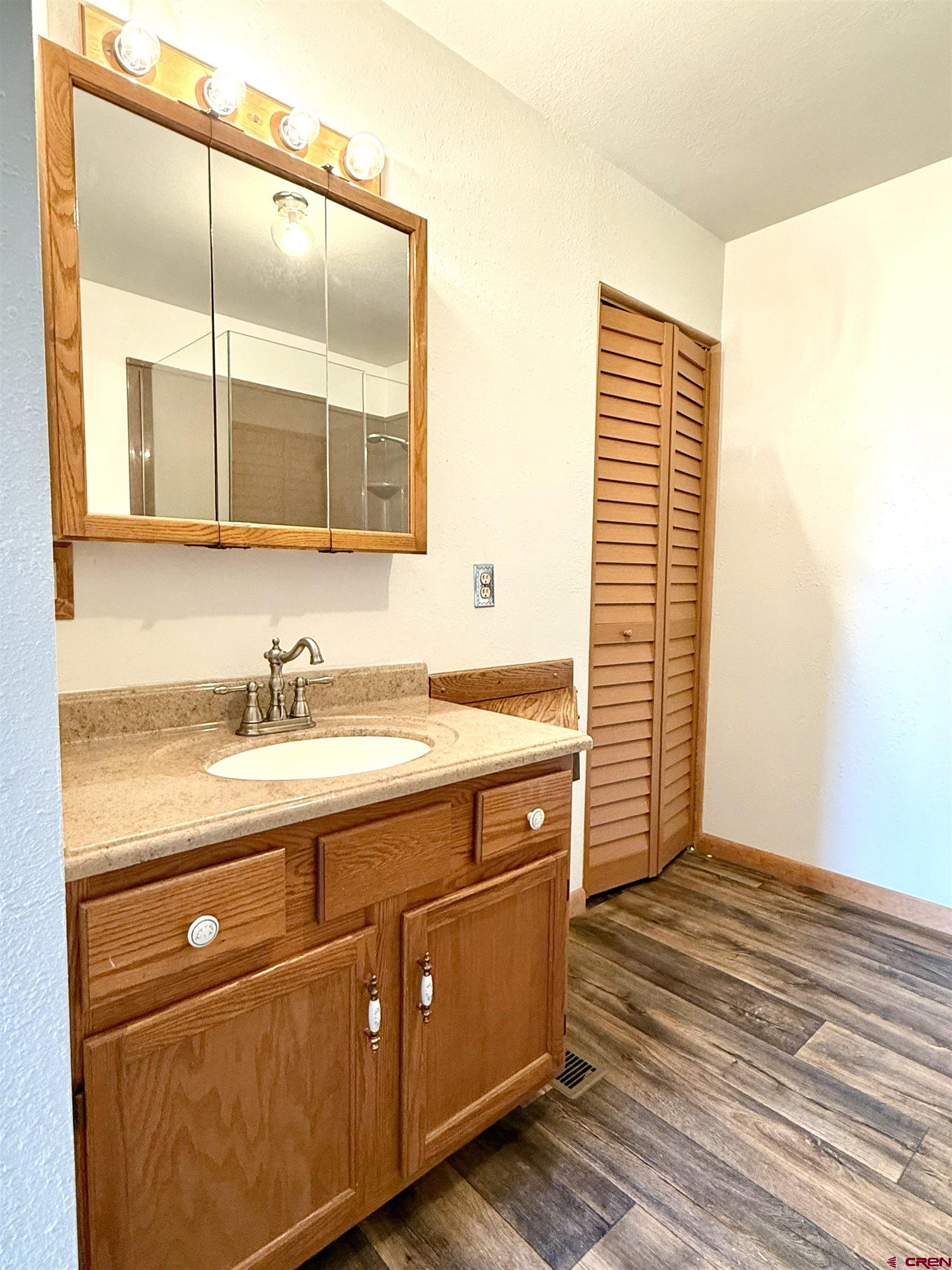 14894 Deer Run Road Delta, CO 81416 - Photo 16 of 40 a bathroom with a sink and a mirror