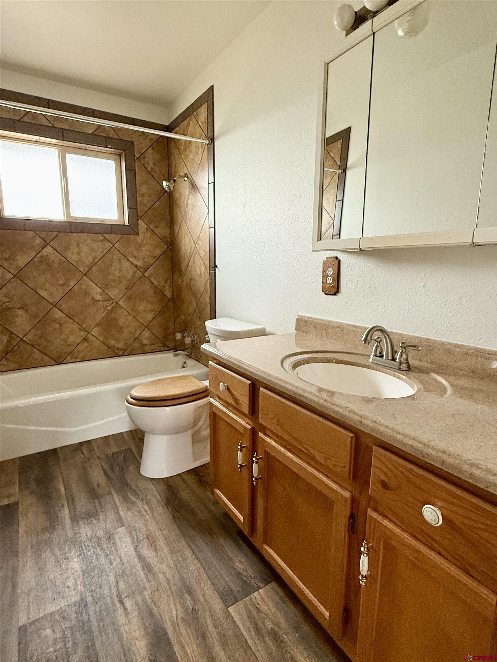 14894 Deer Run Road Delta, CO 81416 - Photo 20 of 40 a bathroom with a granite countertop sink toilet and mirror