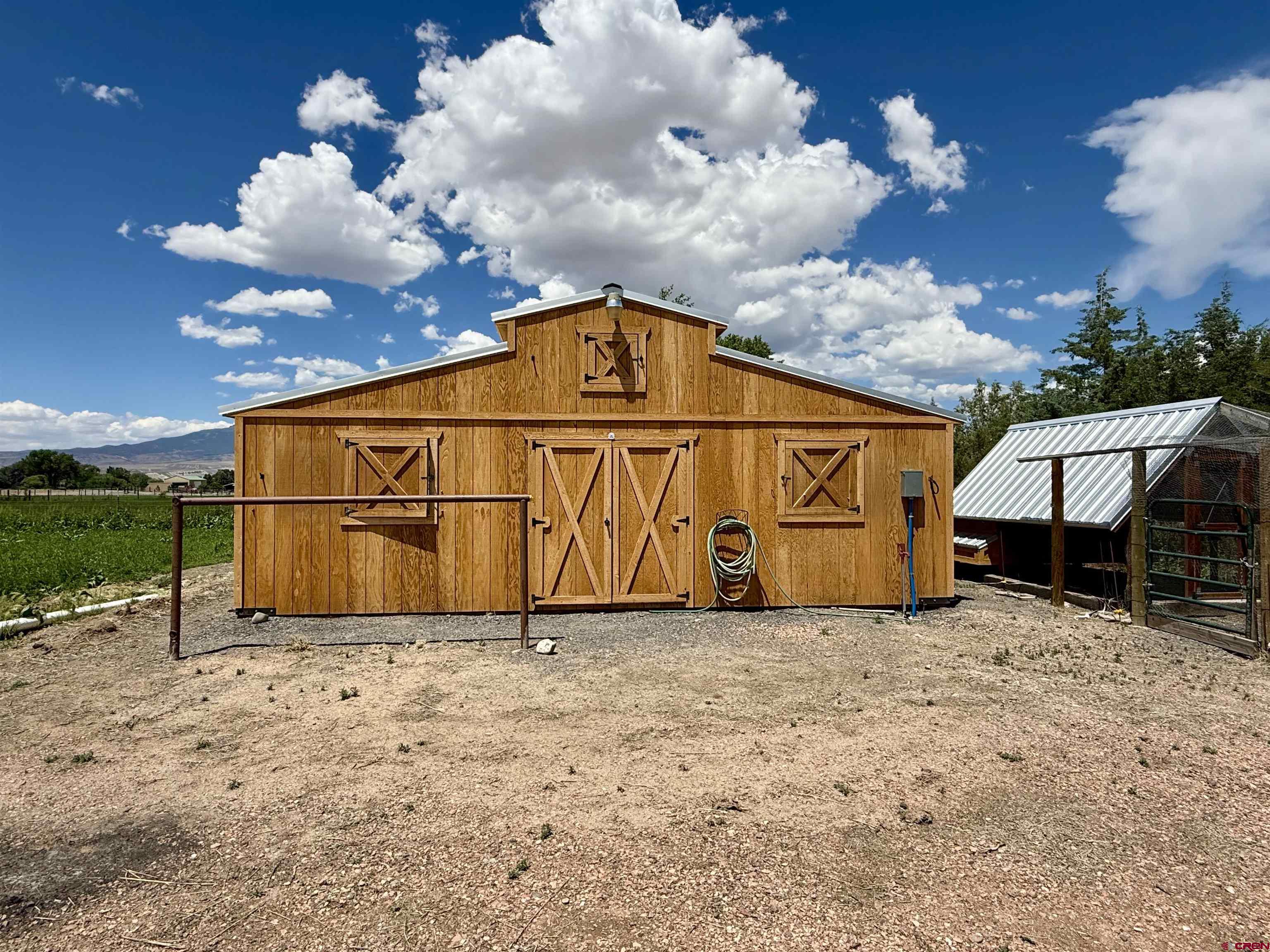 14894 Deer Run Road Delta, CO 81416 - Photo 29 of 40 a view of a barn with wooden fence