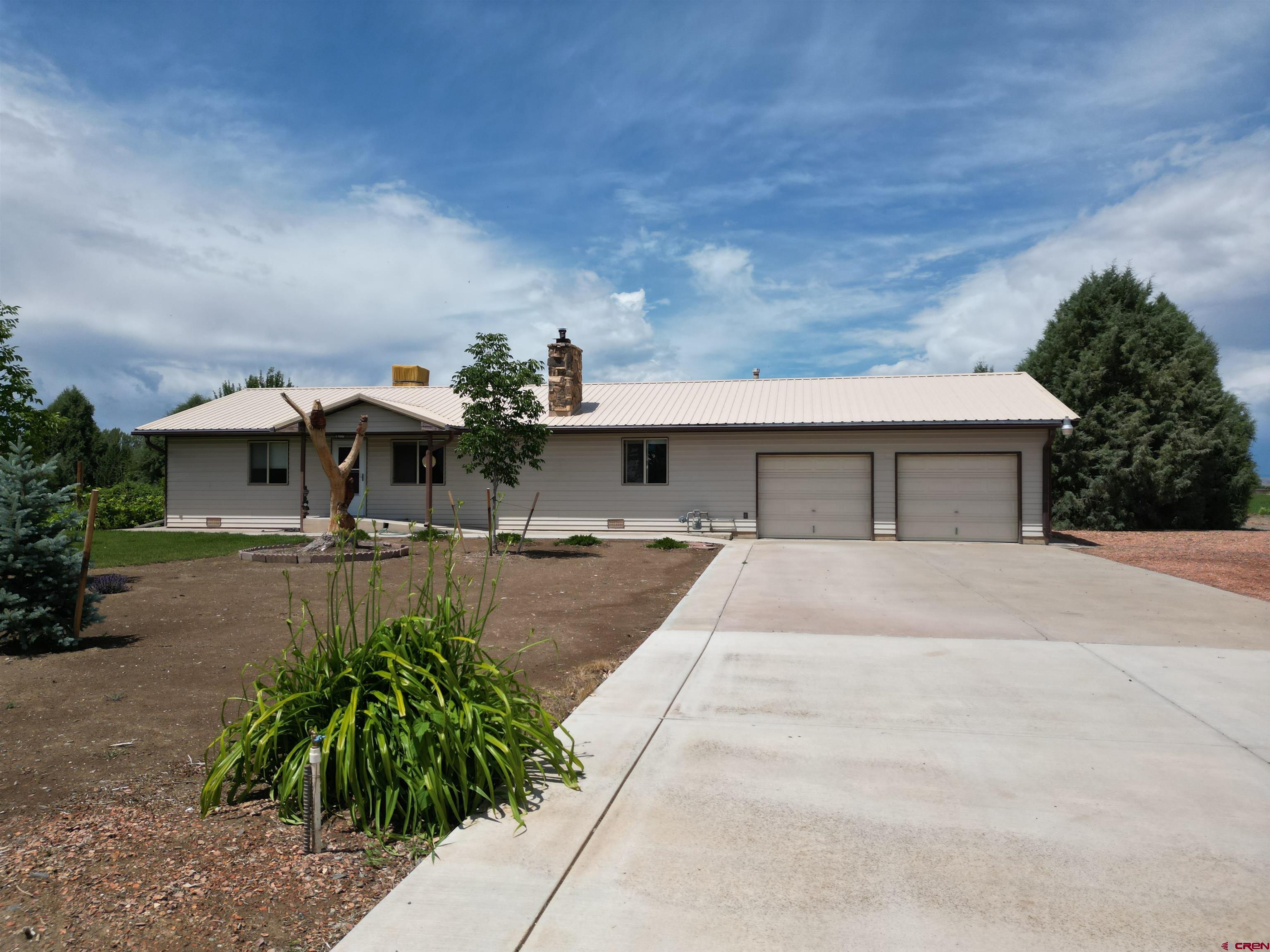 14894 Deer Run Road Delta, CO 81416 - Photo 3 of 40 a front view of a house with garden