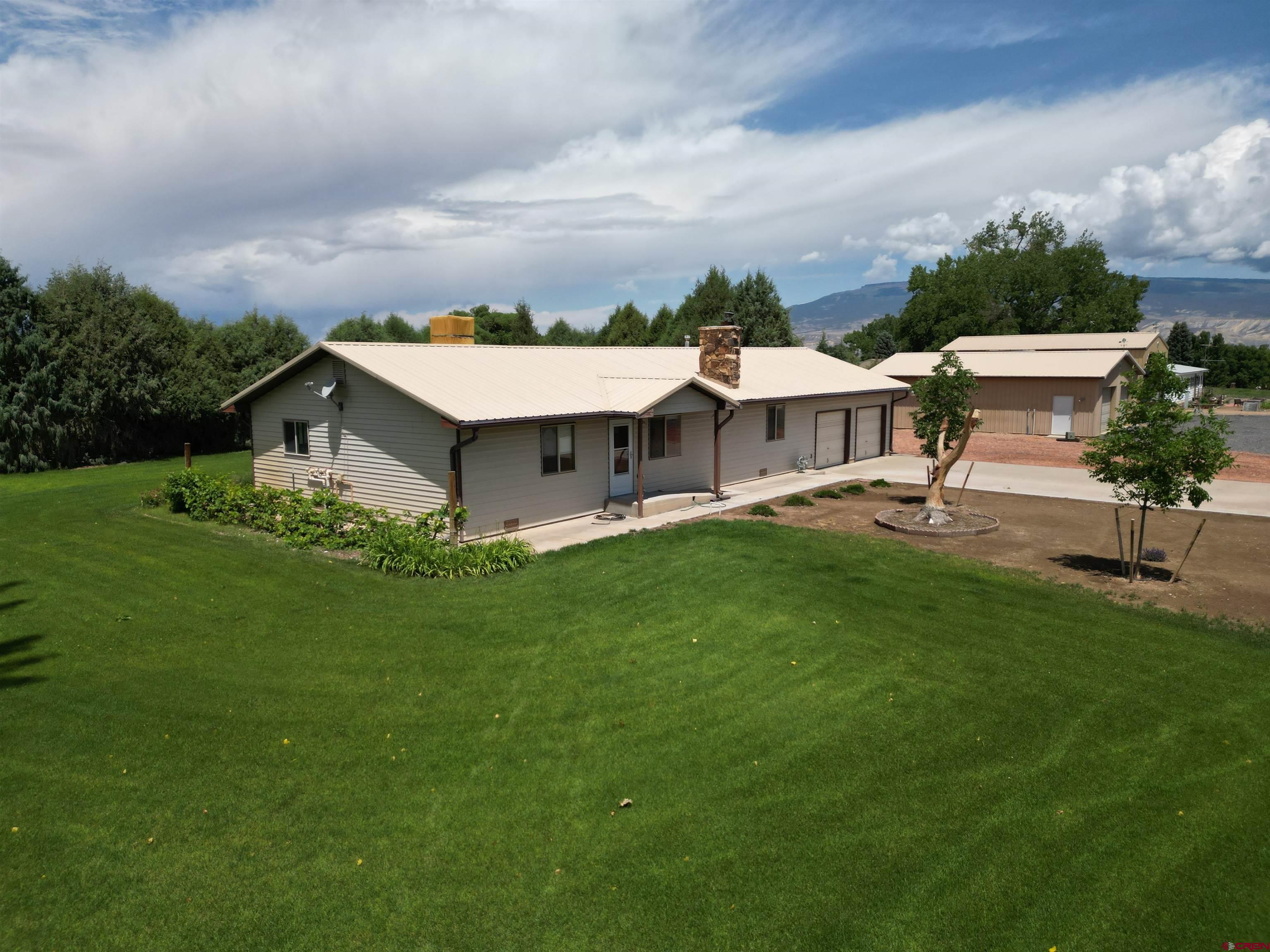14894 Deer Run Road Delta, CO 81416 - Photo 40 of 40 a aerial view of a house with garden and trees